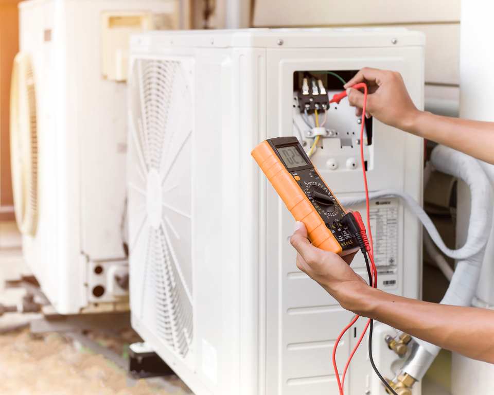 Air Conditioner Repairman Using Electricity Meter To Check Air Conditioner Operation,